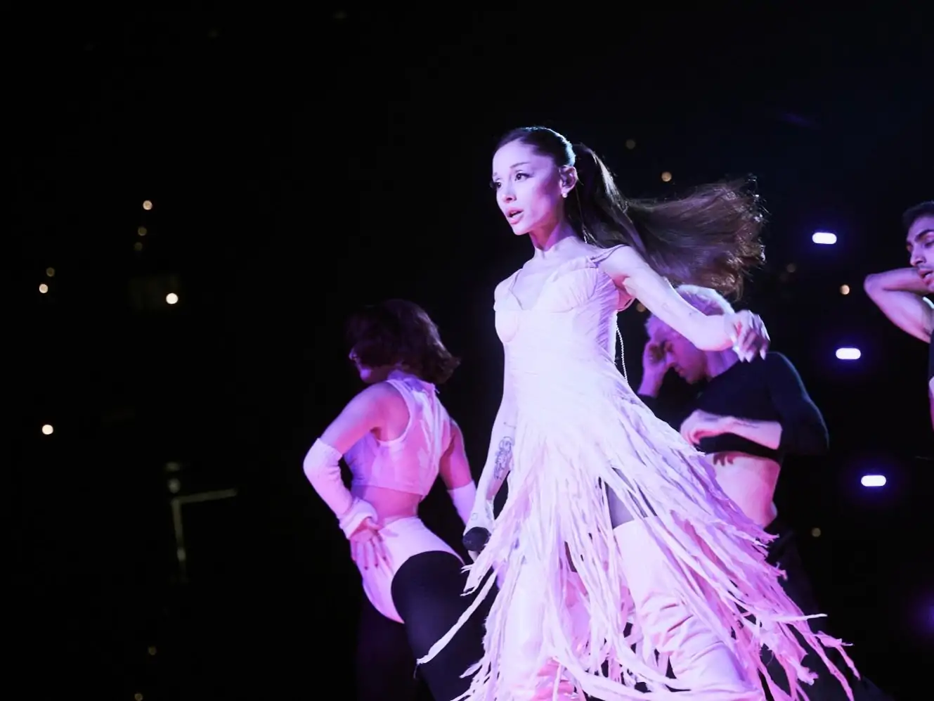 Ariana Grande wearing pink fringed Alexander McQueen by Sean McGirr on the Eternal Sunshine Tour B-stage runway in Oakland